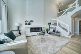 open to above great room with fireplace in the midland showhome by western living homes